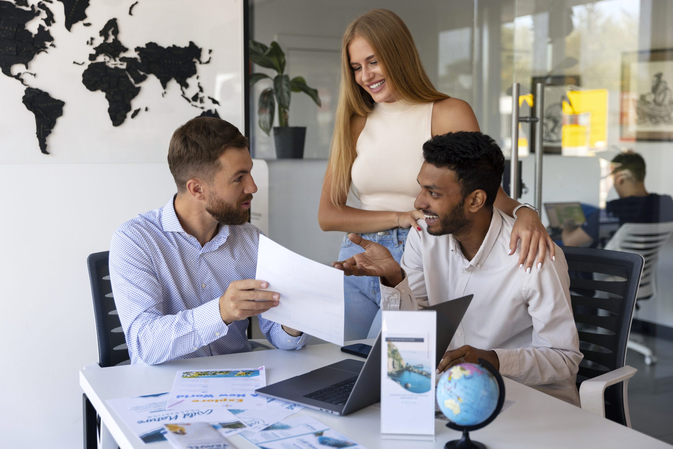 a group of people sitting at a table looking at a piece of paper